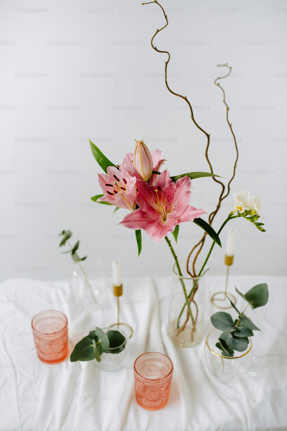 a table topped with vases filled with flowers
