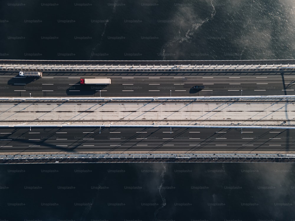 an aerial view of a bridge with cars on it
