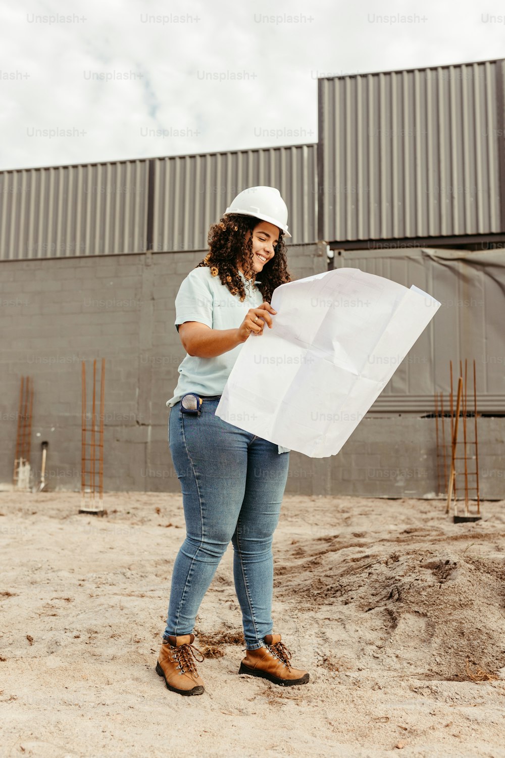 a woman in a hard hat holding a piece of paper
