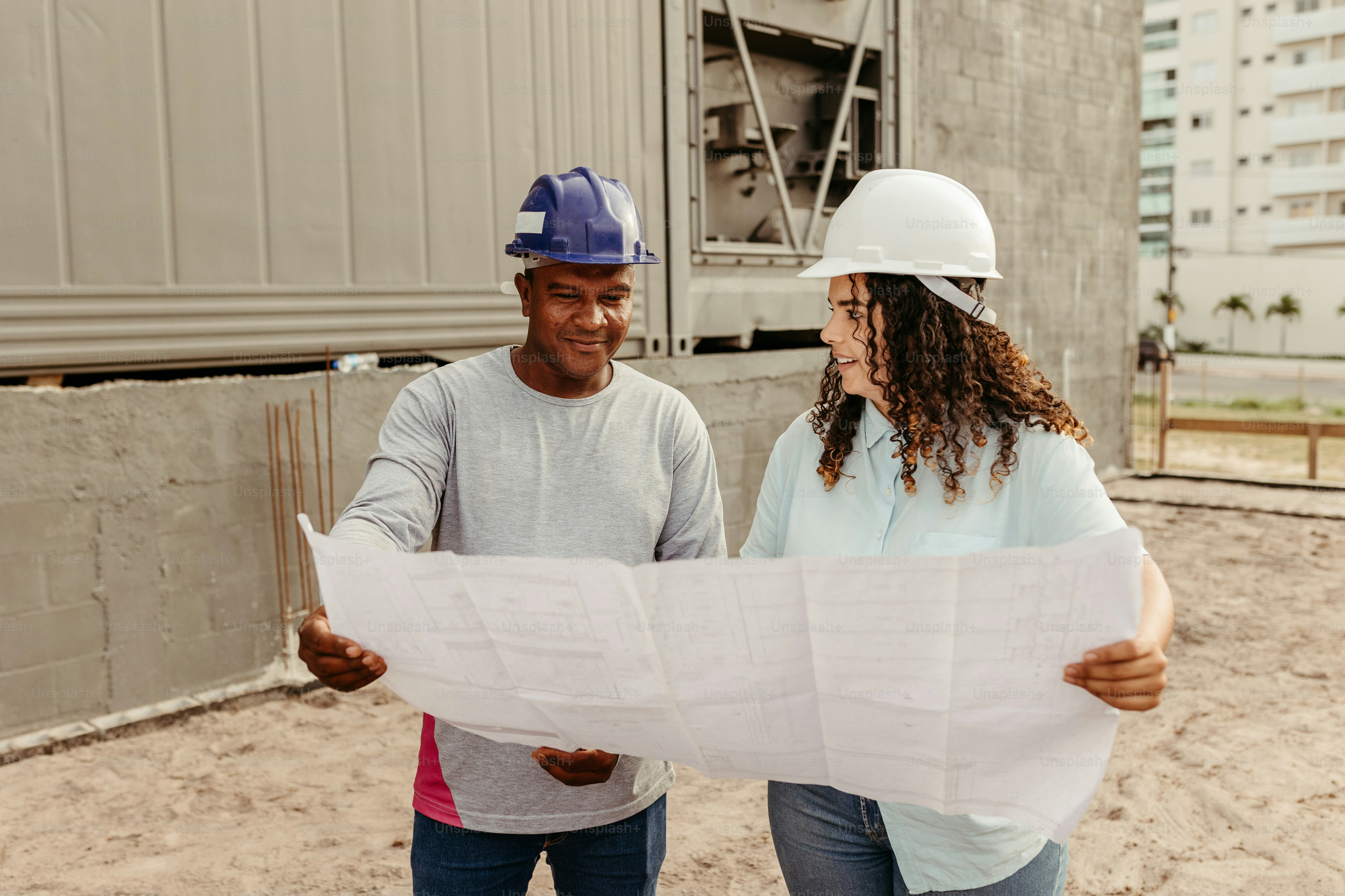 a couple of people that are looking at a blueprint