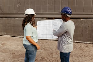 a man and a woman looking at a construction plan