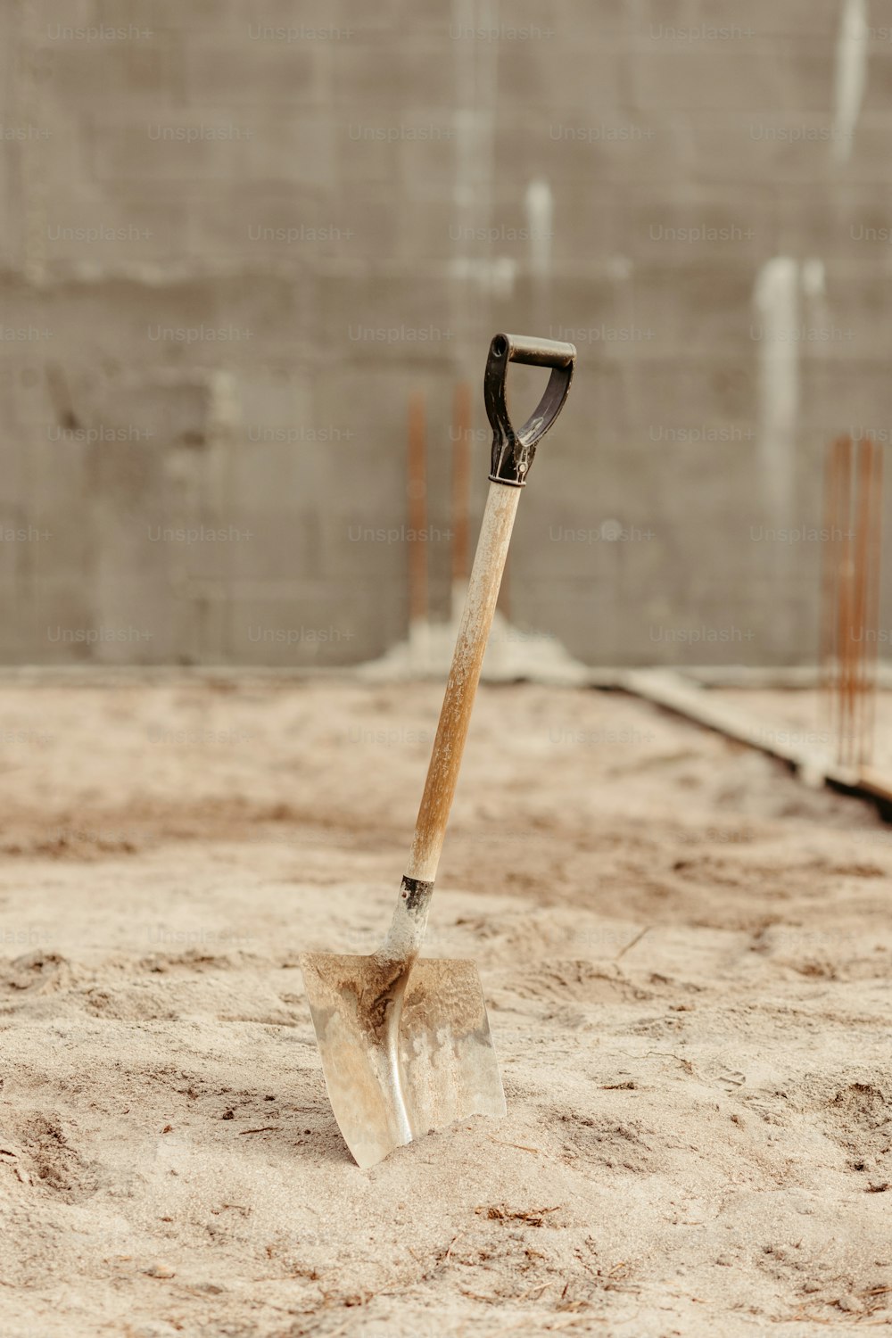 a shovel sitting on top of a sandy ground