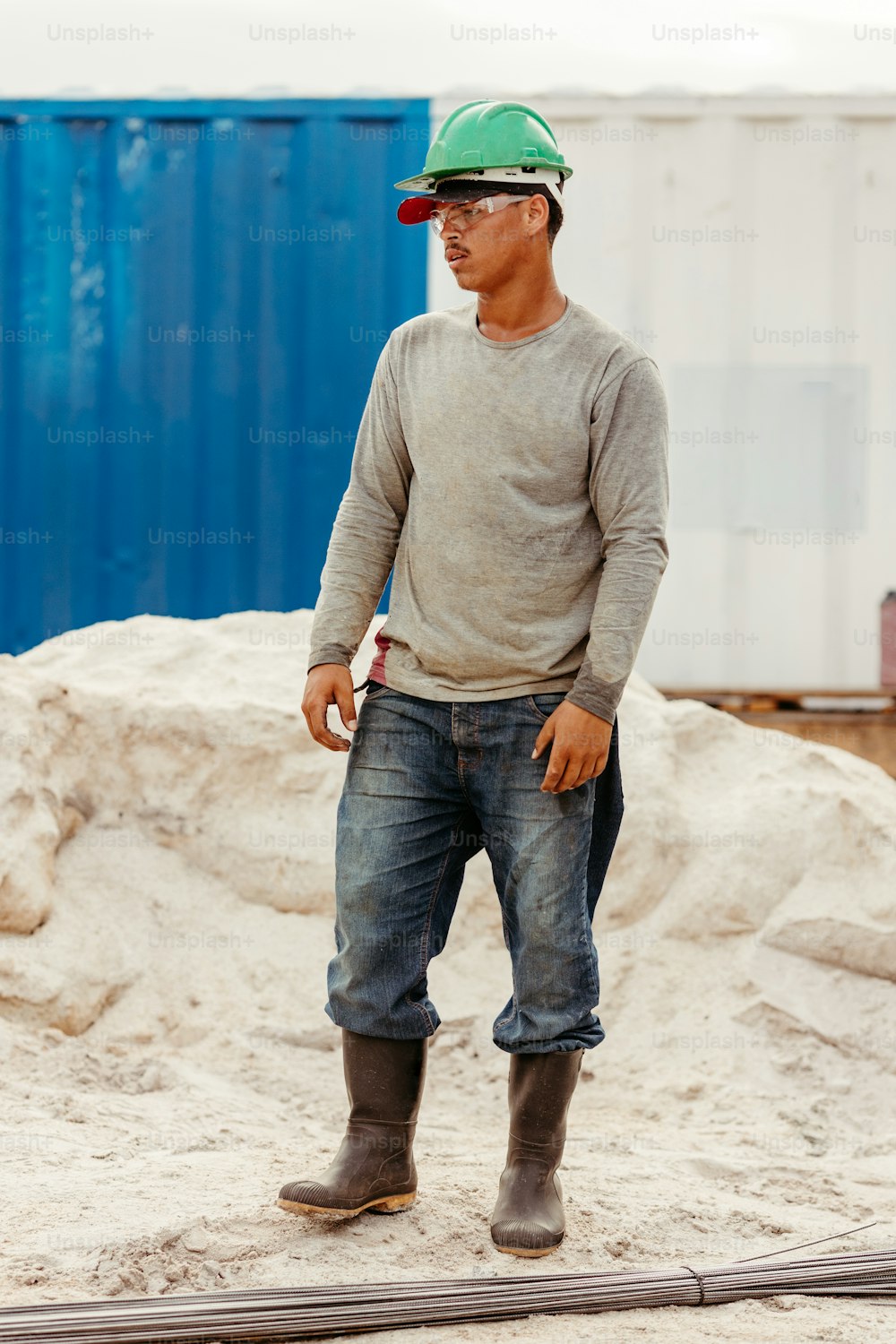 a man wearing a hard hat and jeans