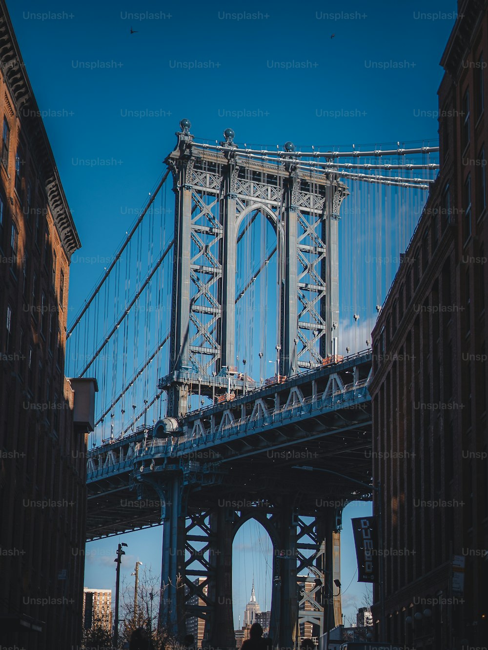 a large bridge spanning over a city with tall buildings