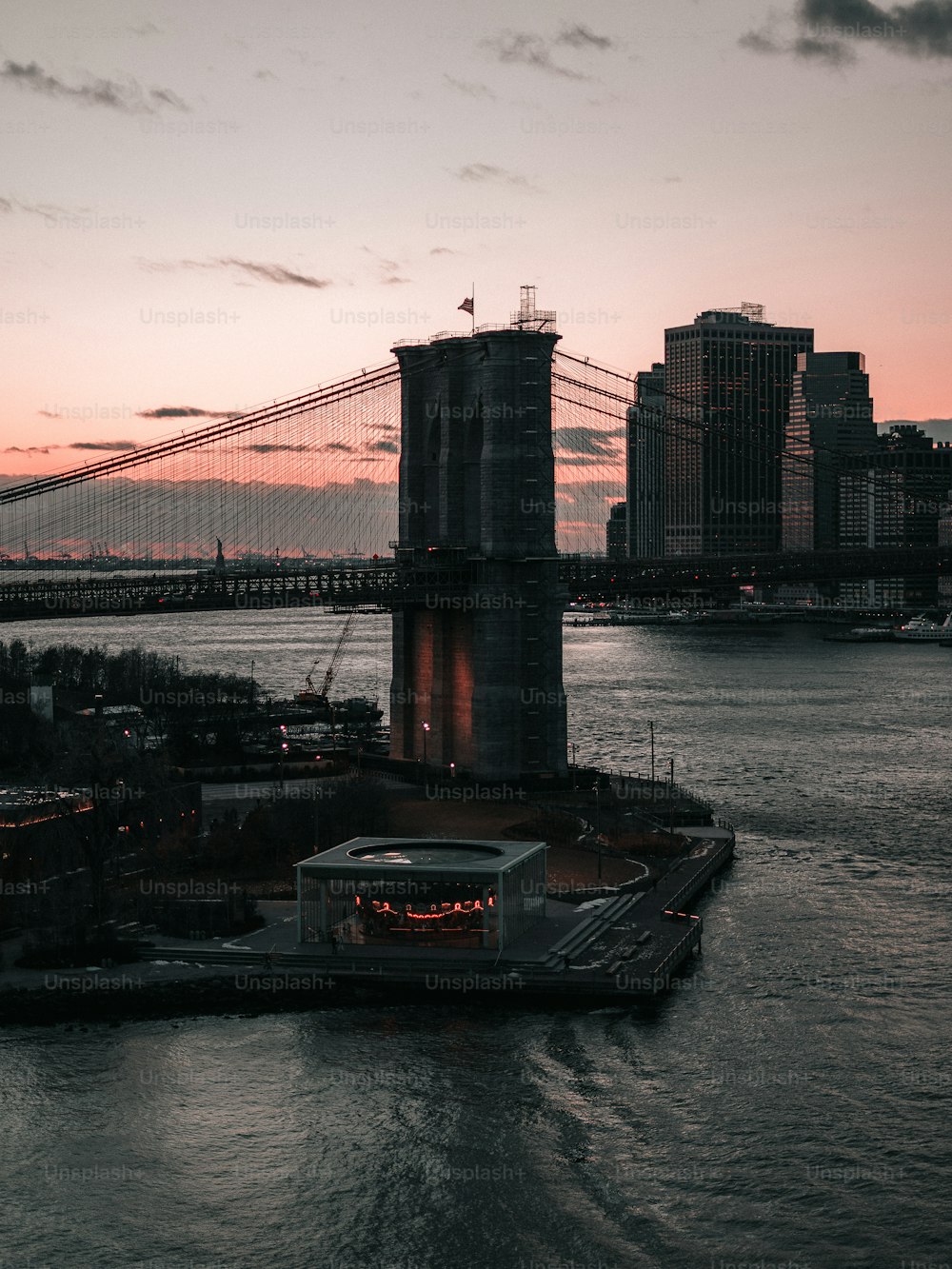 a large bridge spanning over a river next to a tall building