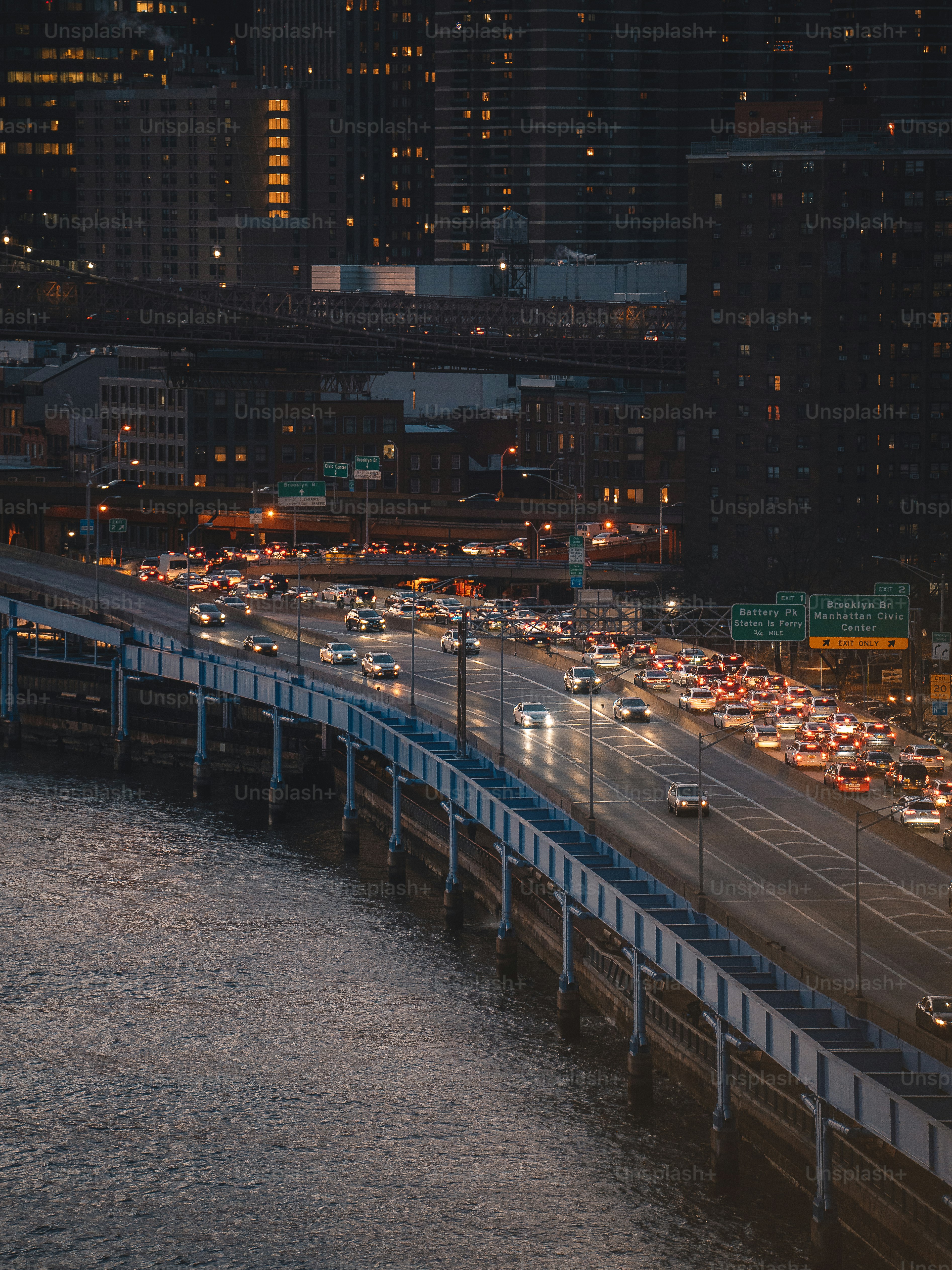 a highway filled with lots of traffic next to tall buildings