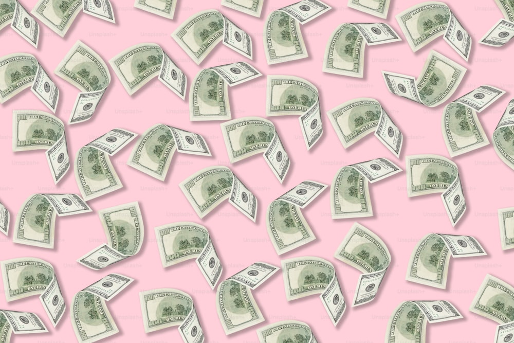 a lot of money falling down on a pink background