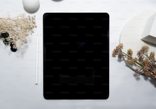 a tablet computer sitting on top of a white table