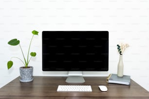 un monitor di computer seduto sopra una scrivania di legno