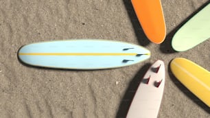 a group of surfboards laying on top of a sandy beach