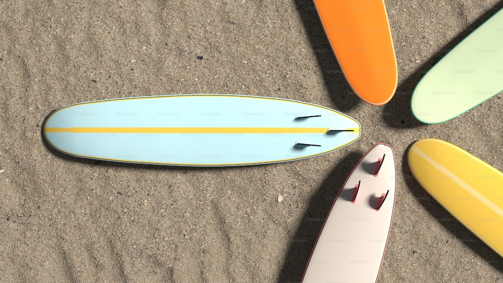 a group of surfboards laying on top of a sandy beach