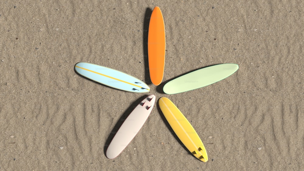 a group of surfboards laying on top of a sandy beach