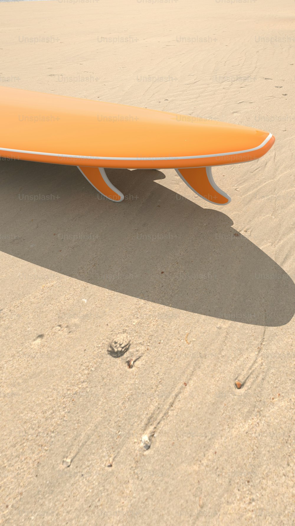 a surfboard laying on top of a sandy beach