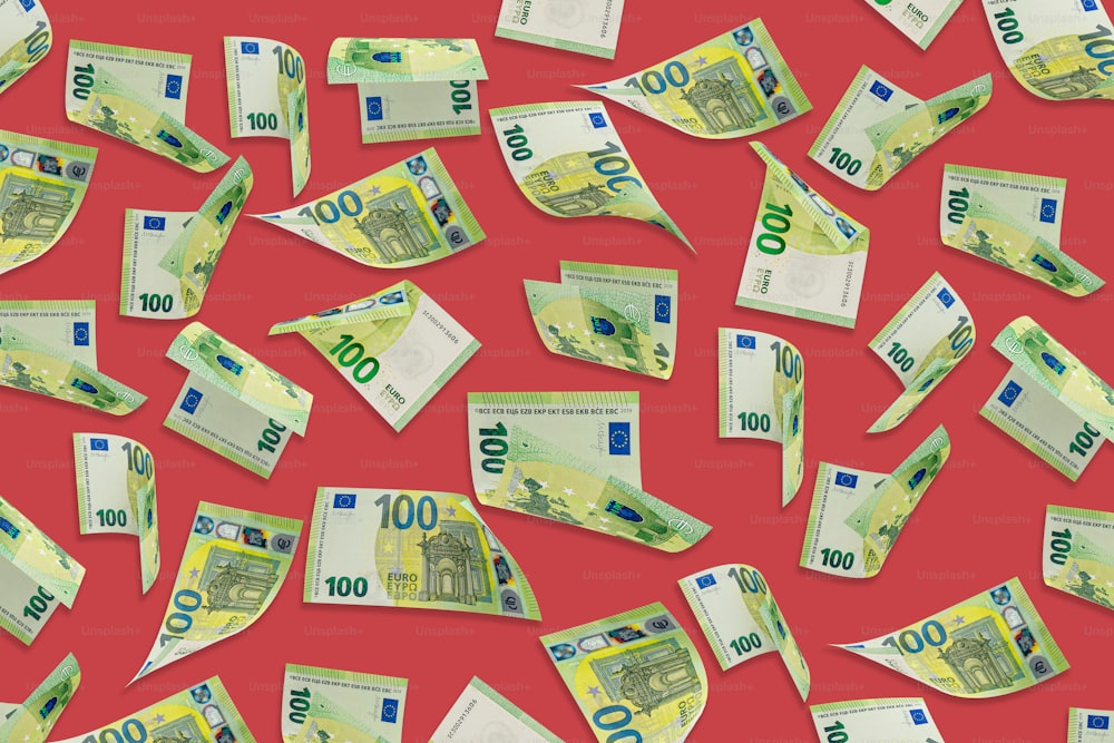 a lot of money is scattered on a red background
