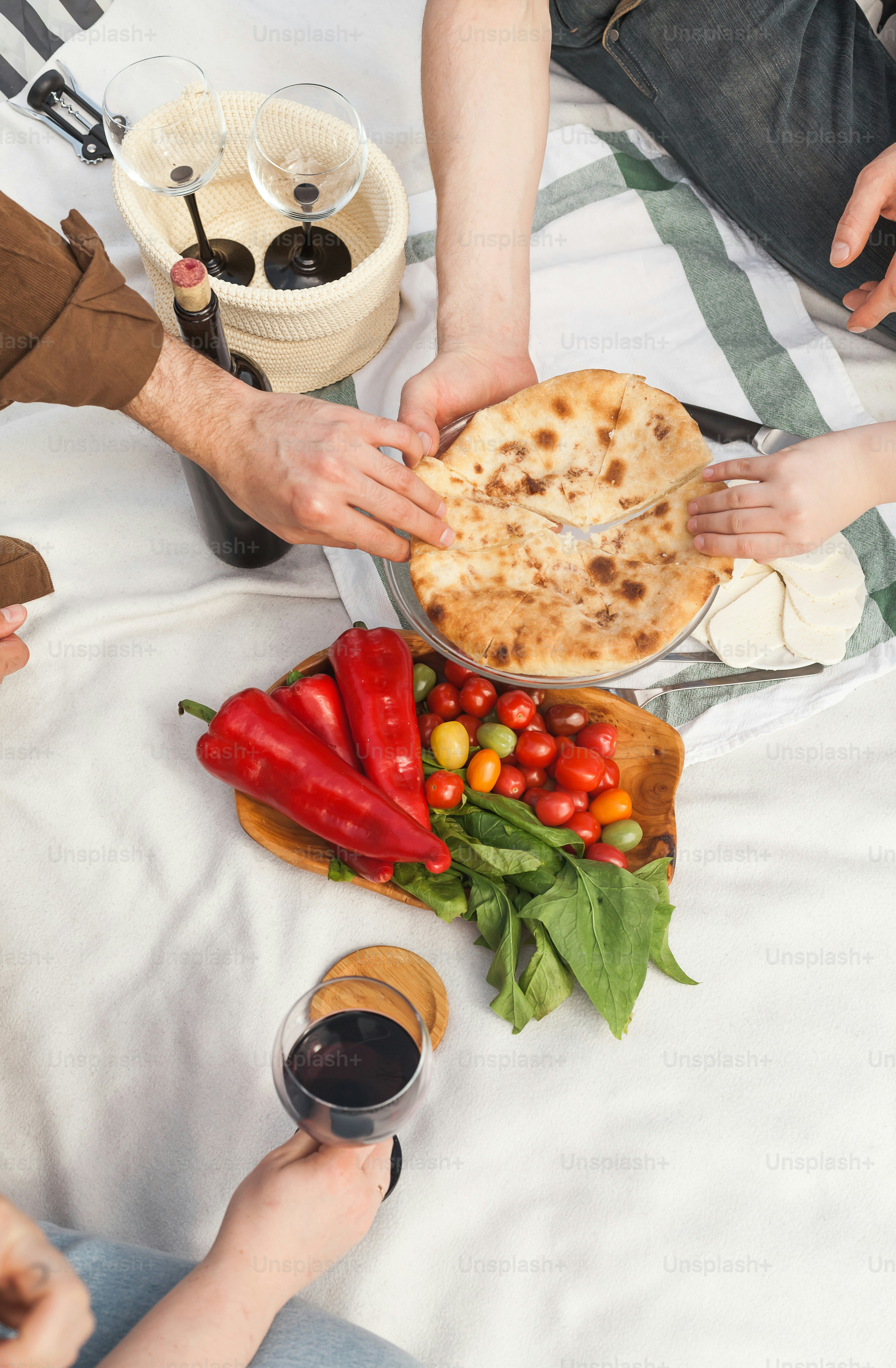 A group of people sitting around a table with food photo – Food Image ...