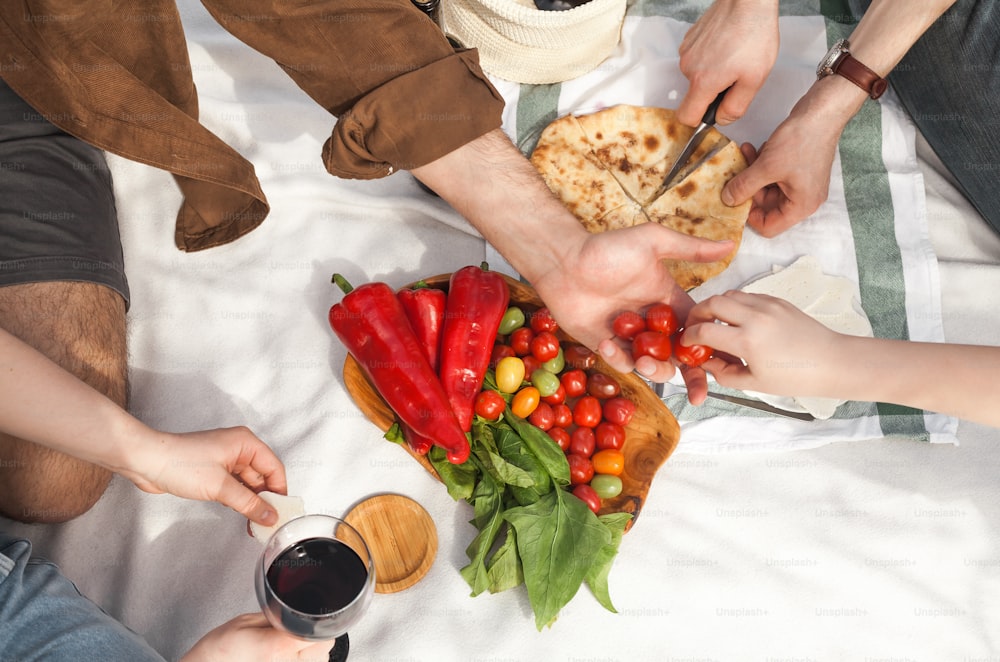 a group of people sitting around a table with food