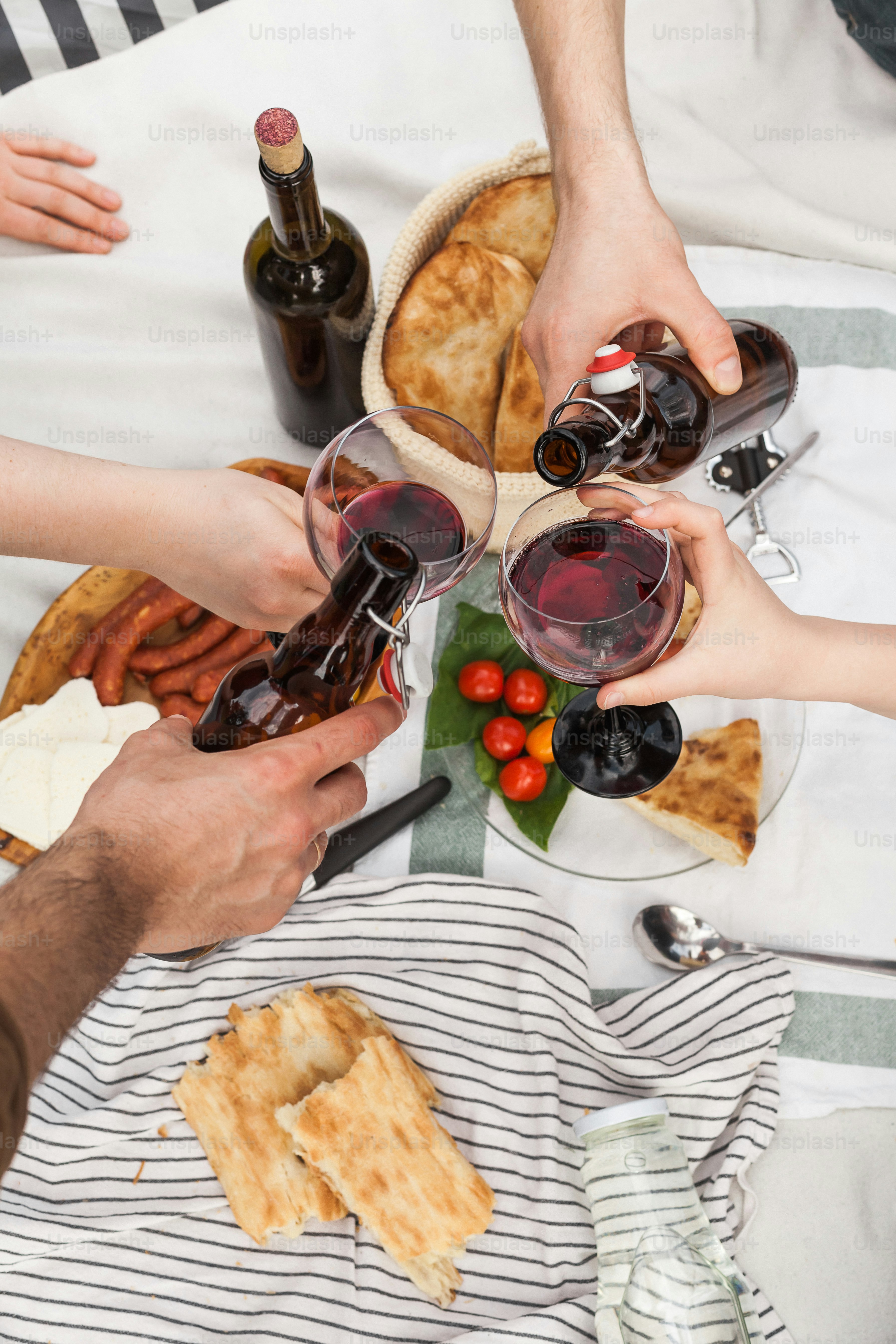 A group of people sitting around a table with food photo – Food Image ...