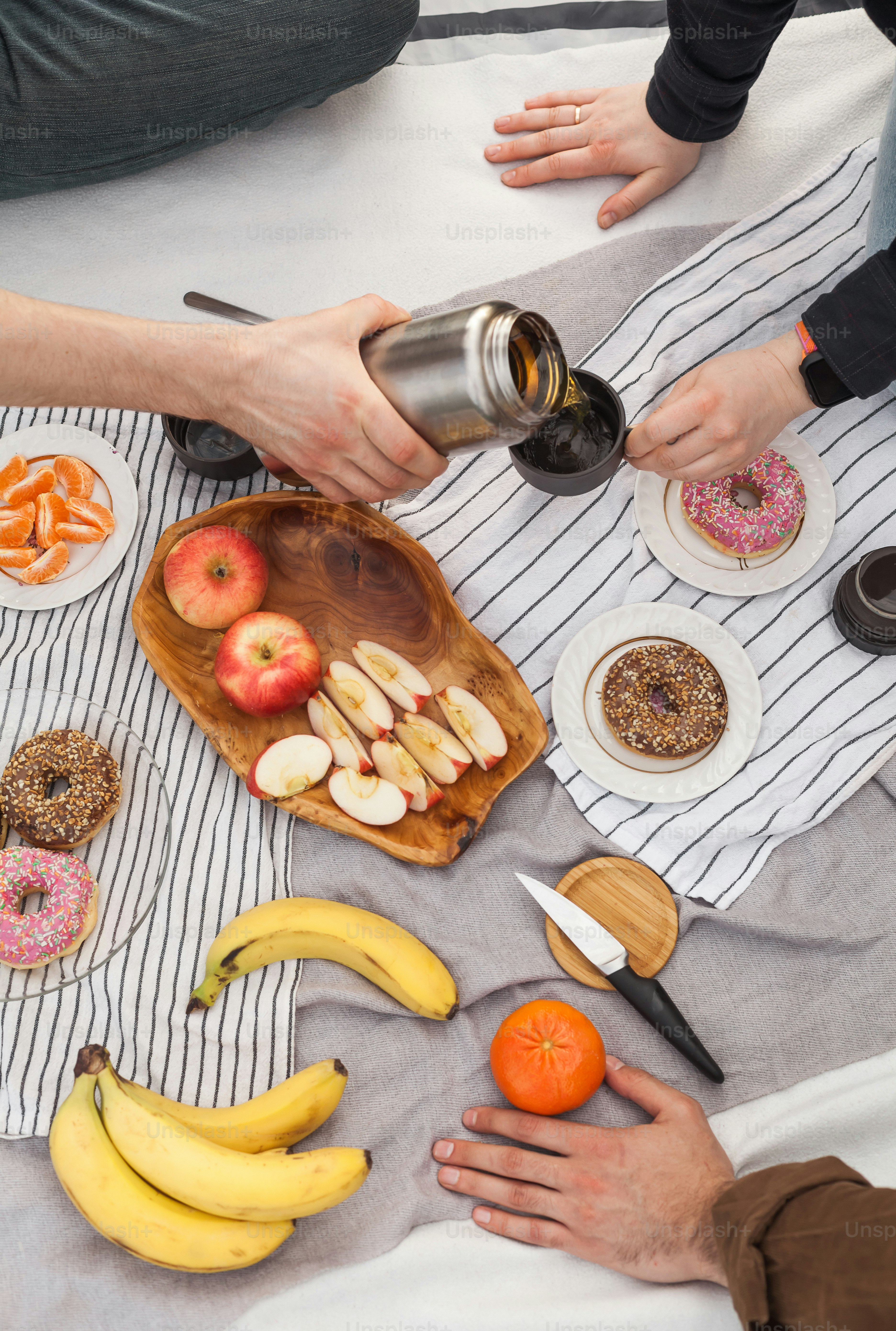 a couple of people sitting at a table with plates of food