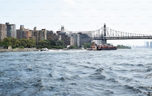 a large boat in a body of water near a bridge