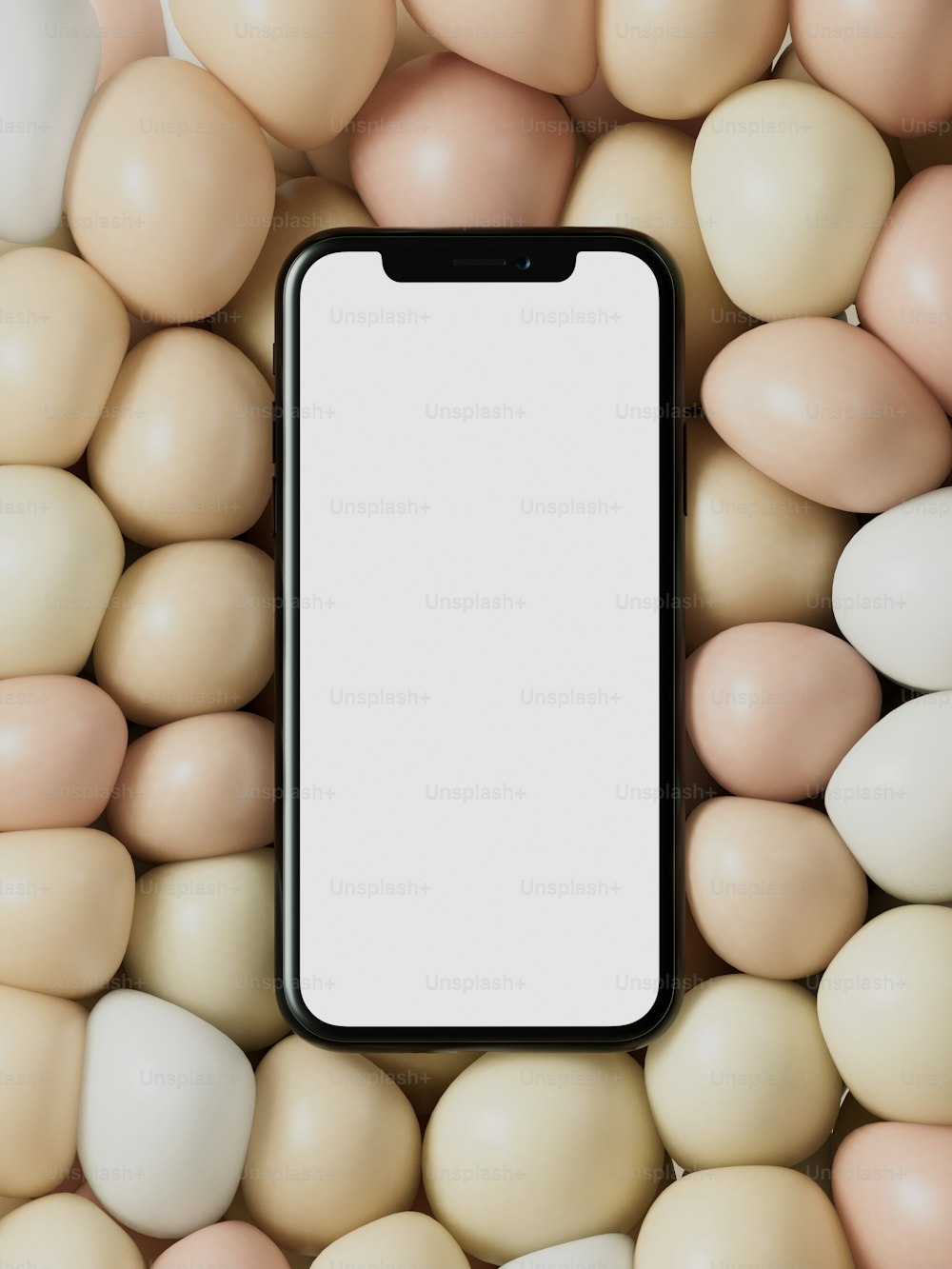 a cell phone sitting on top of a pile of eggs