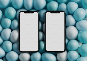 two black cell phones surrounded by blue and white balls
