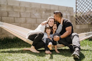 a family sitting in a hammock together