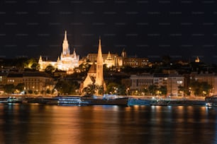 a night view of a city with a castle in the background