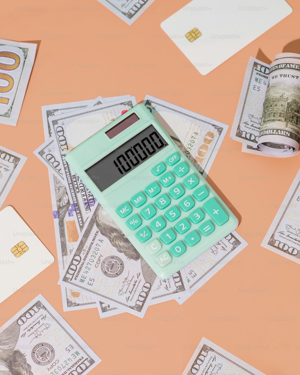 a calculator sitting on top of a pile of money