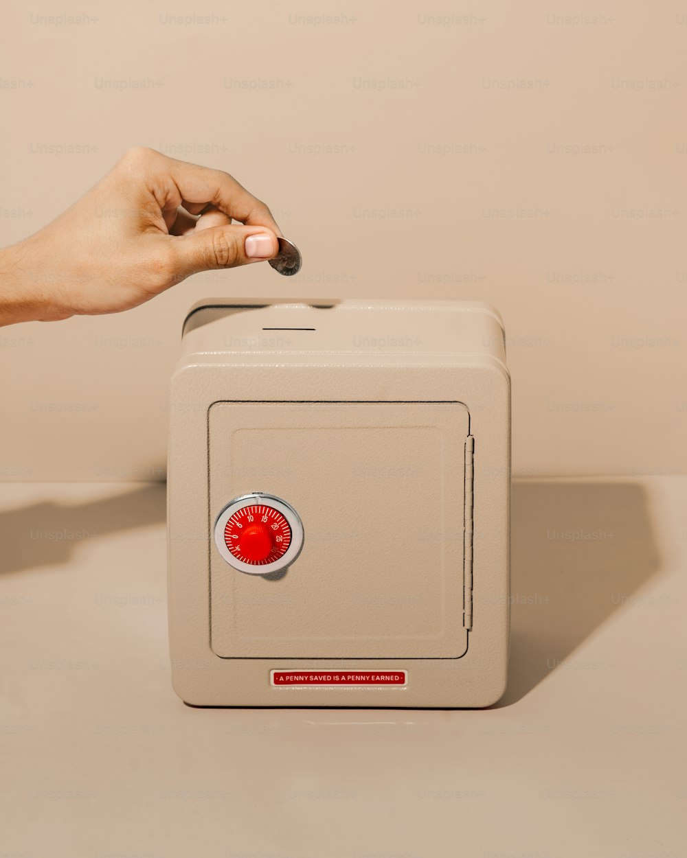 a person's hand reaching for a safe box