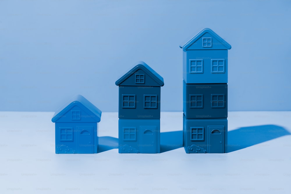 a group of blue houses sitting next to each other