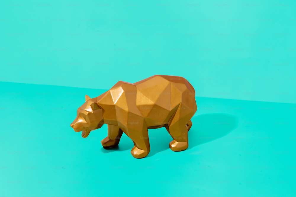 a brown bear statue on a blue and green background