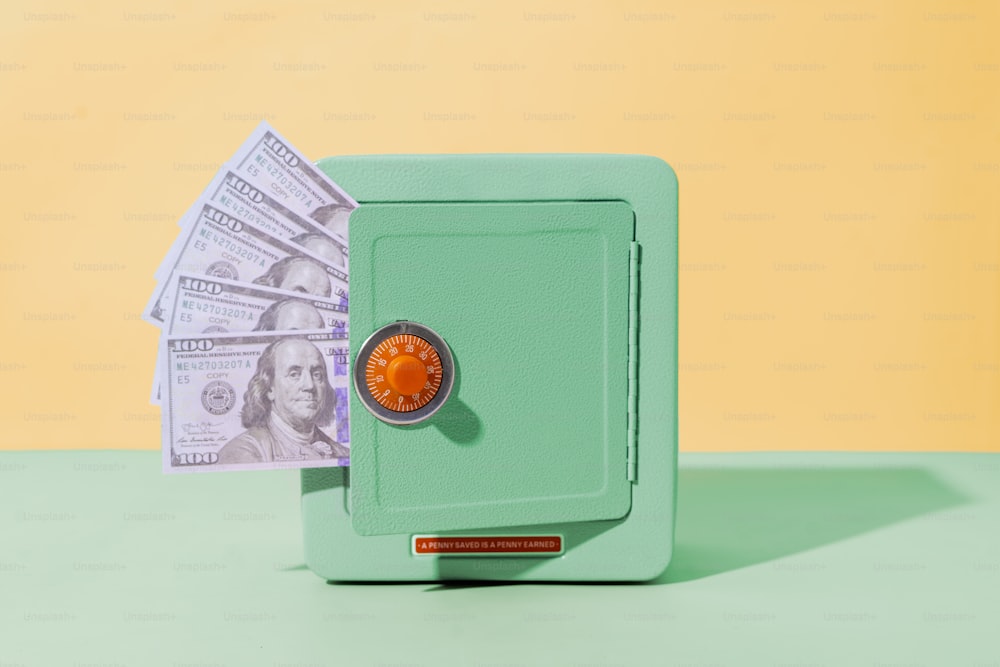 a green safe with money sticking out of it