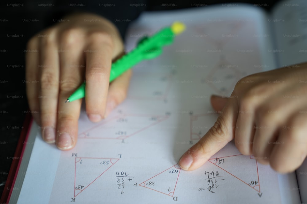 a close up of a person writing on a piece of paper