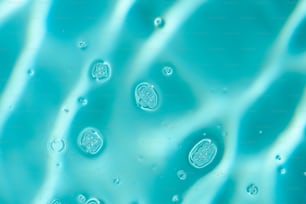 a close up of a blue liquid with bubbles