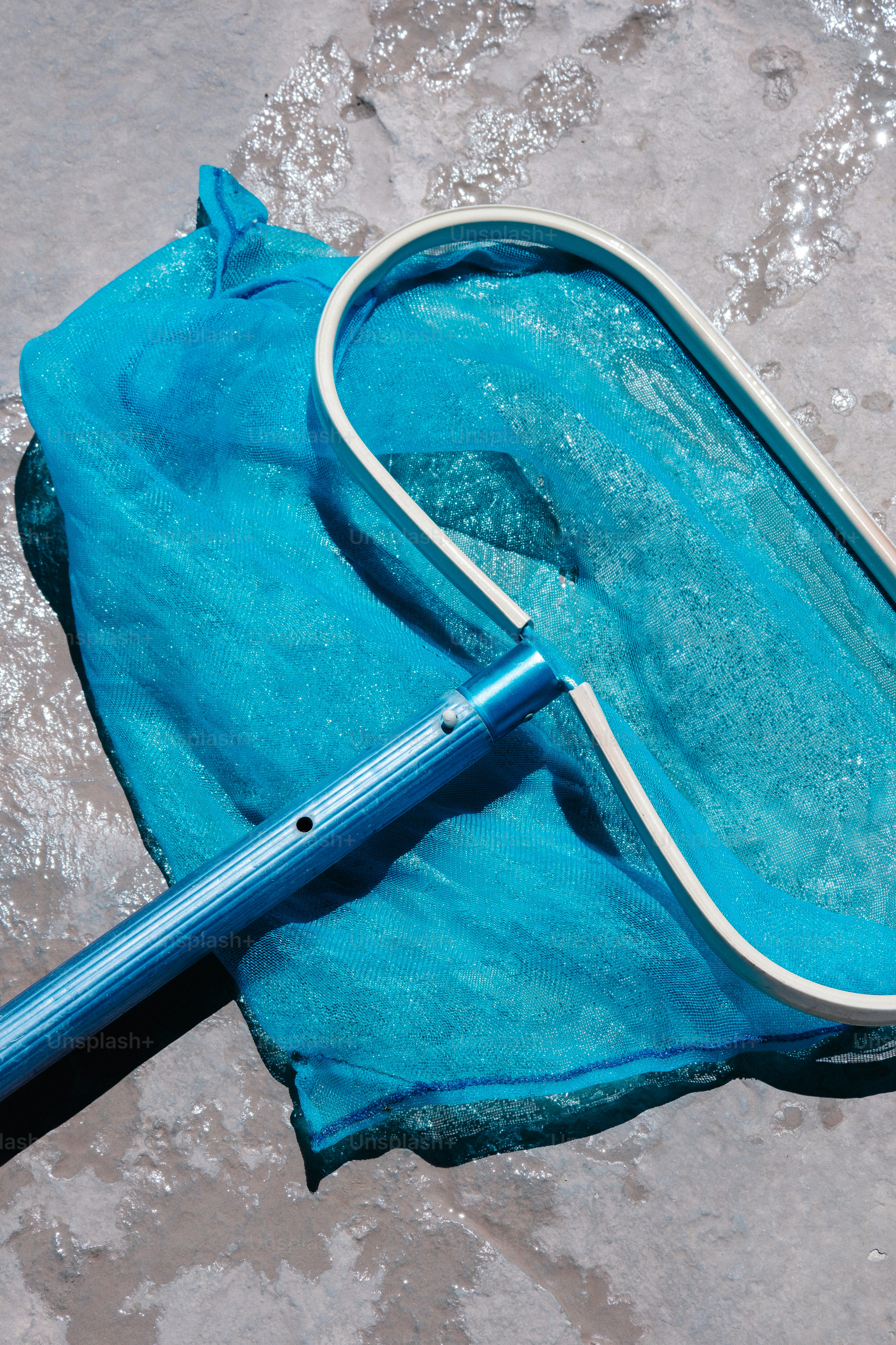 un ombrello blu che giace sulla cima di una spiaggia sabbiosa
