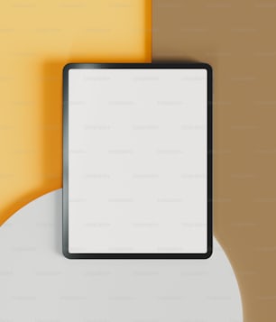 a white and black square frame on a yellow and brown wall