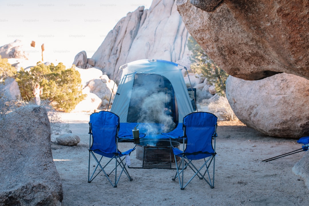 a tent set up in the middle of a rocky area