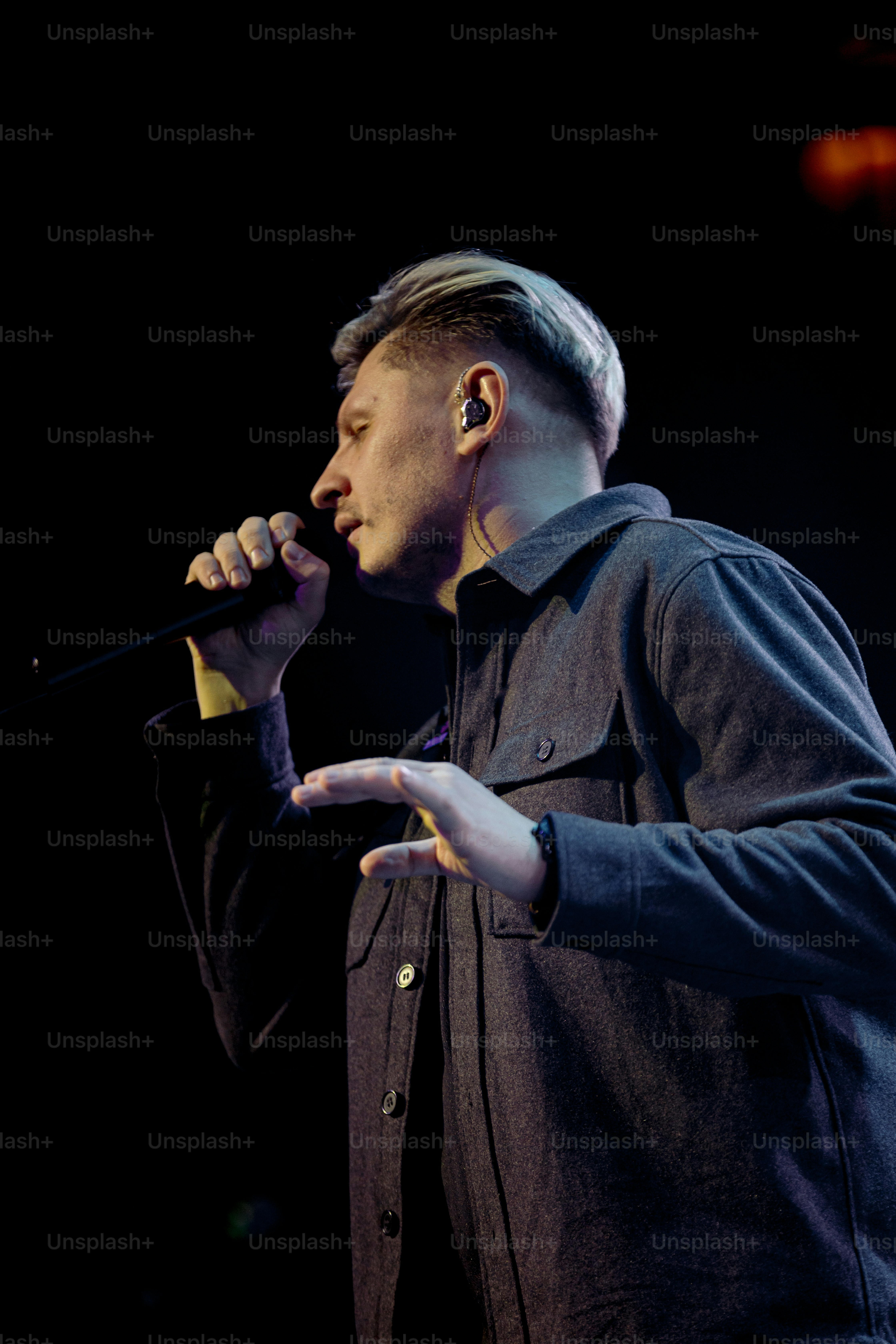 a man holding a microphone in his right hand