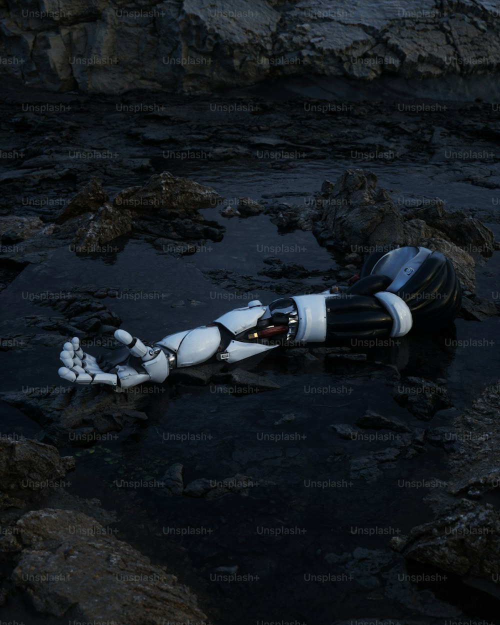 a robot is laying on the rocks in the water