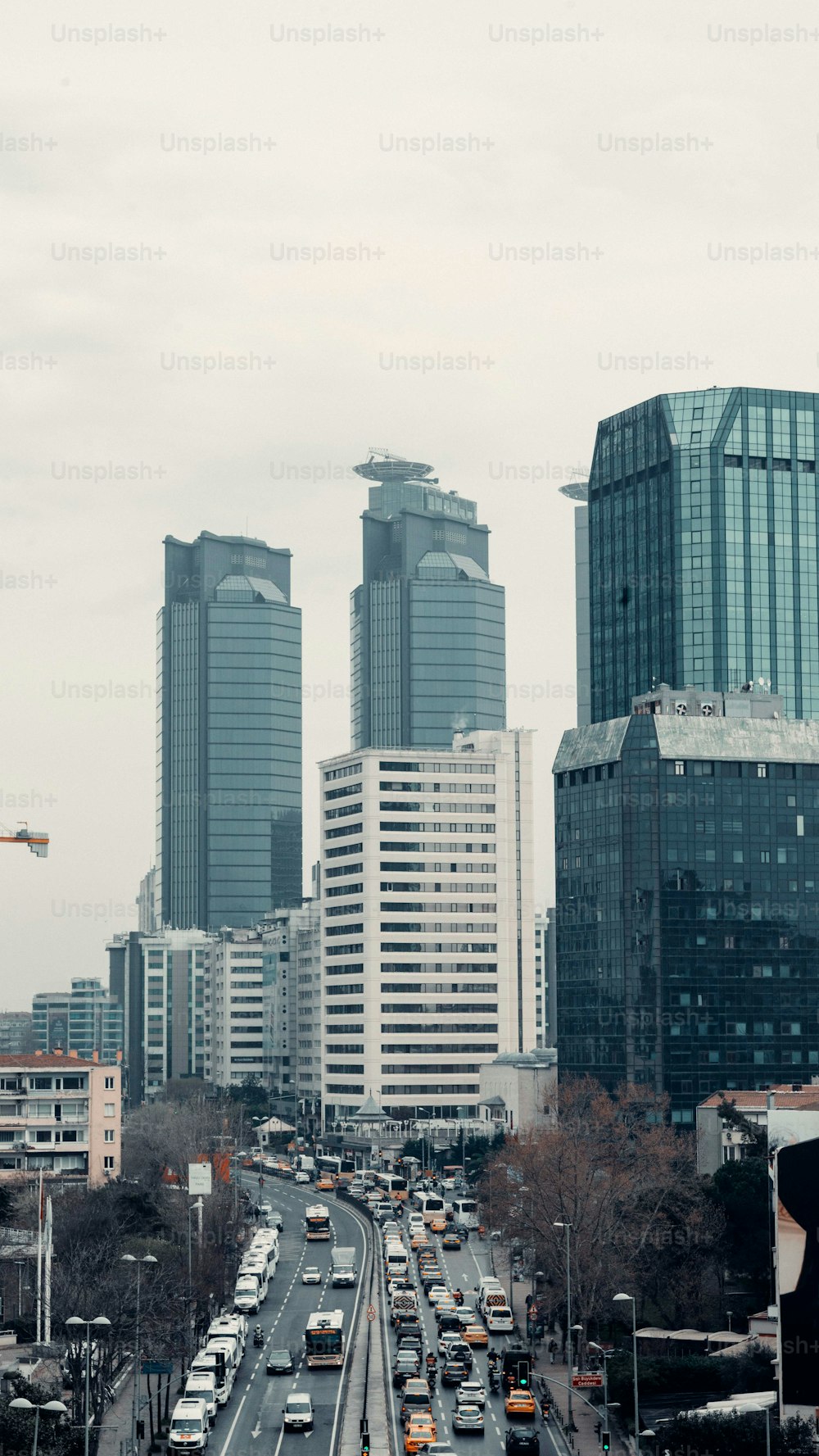 a view of a busy city street with tall buildings in the background