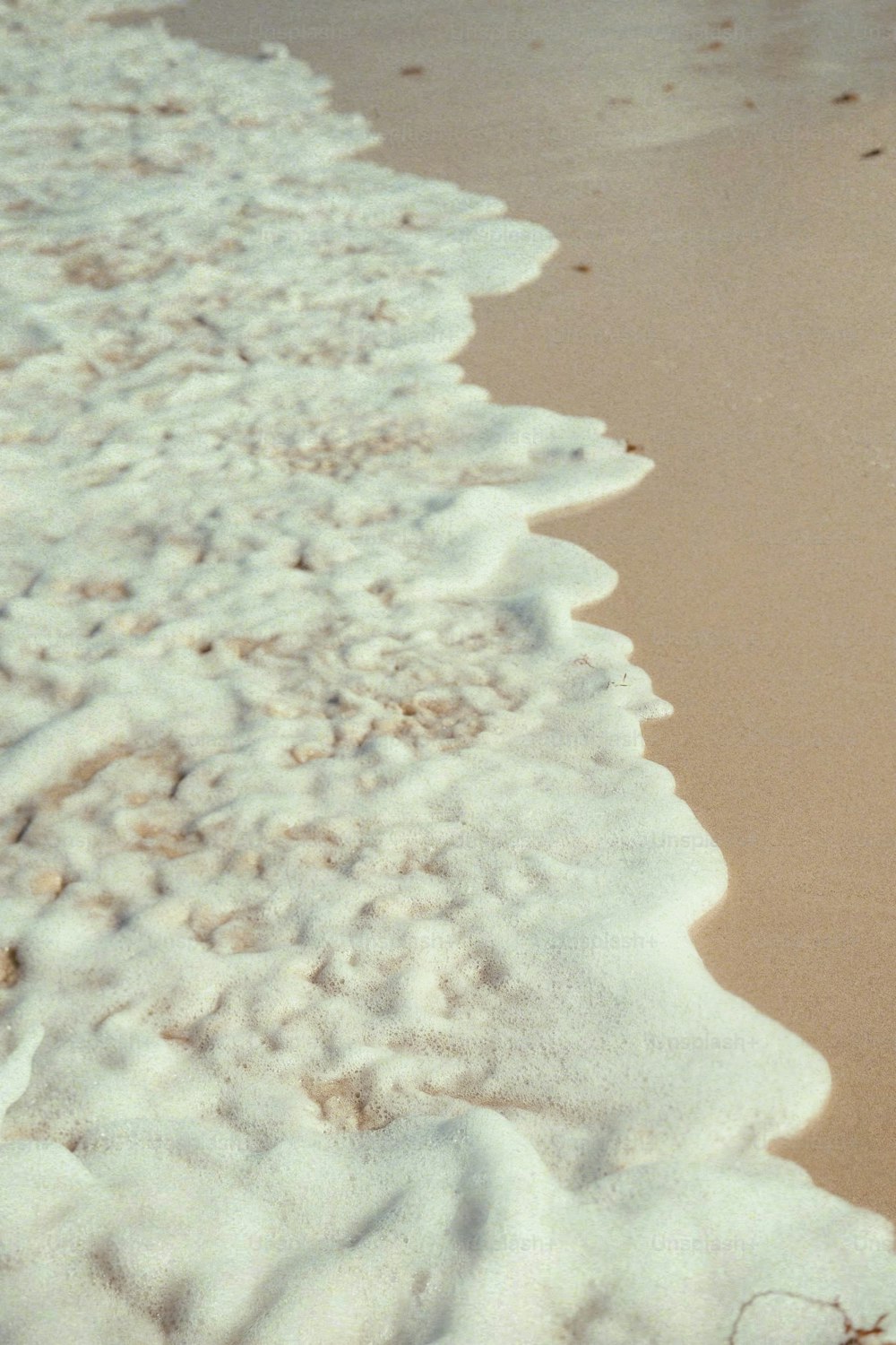 a surfboard sitting on top of a sandy beach