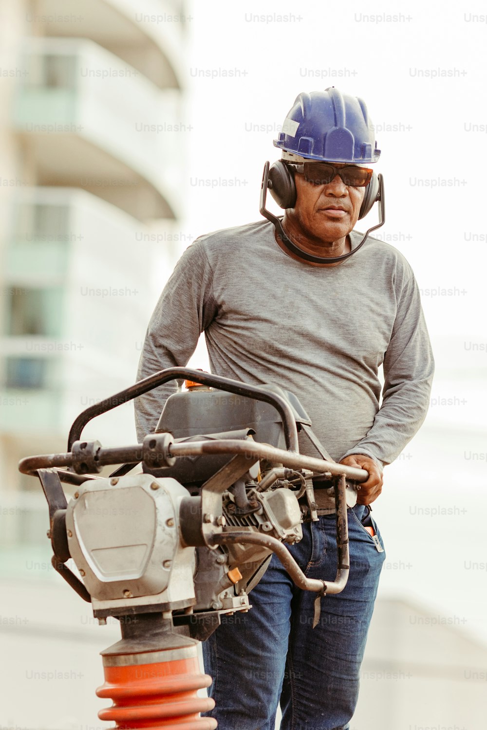 um homem usando um capacete em pé ao lado de uma máquina
