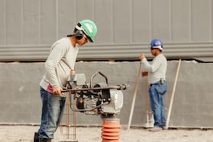 a couple of men working on a construction project