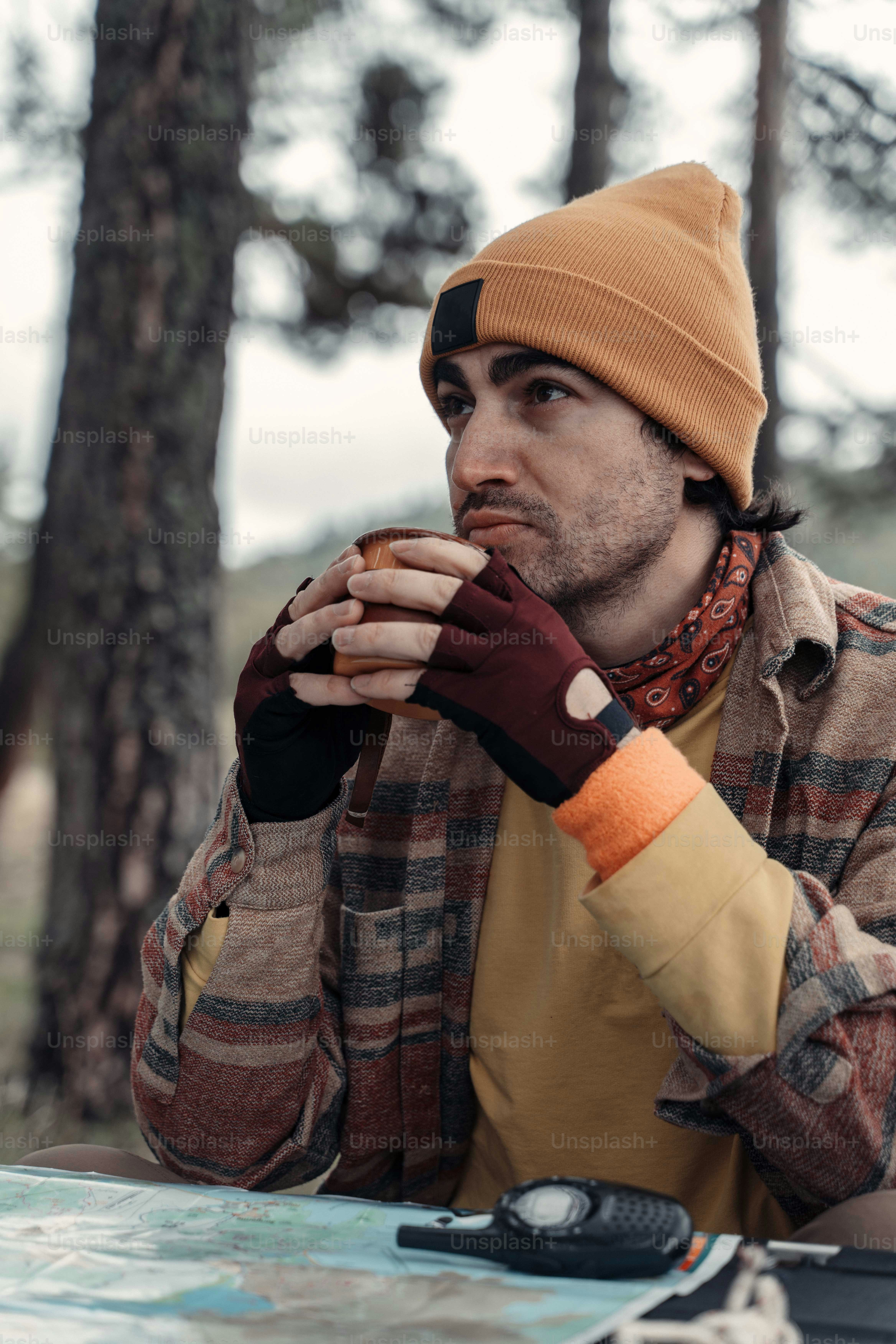 a man sitting at a table eating a doughnut