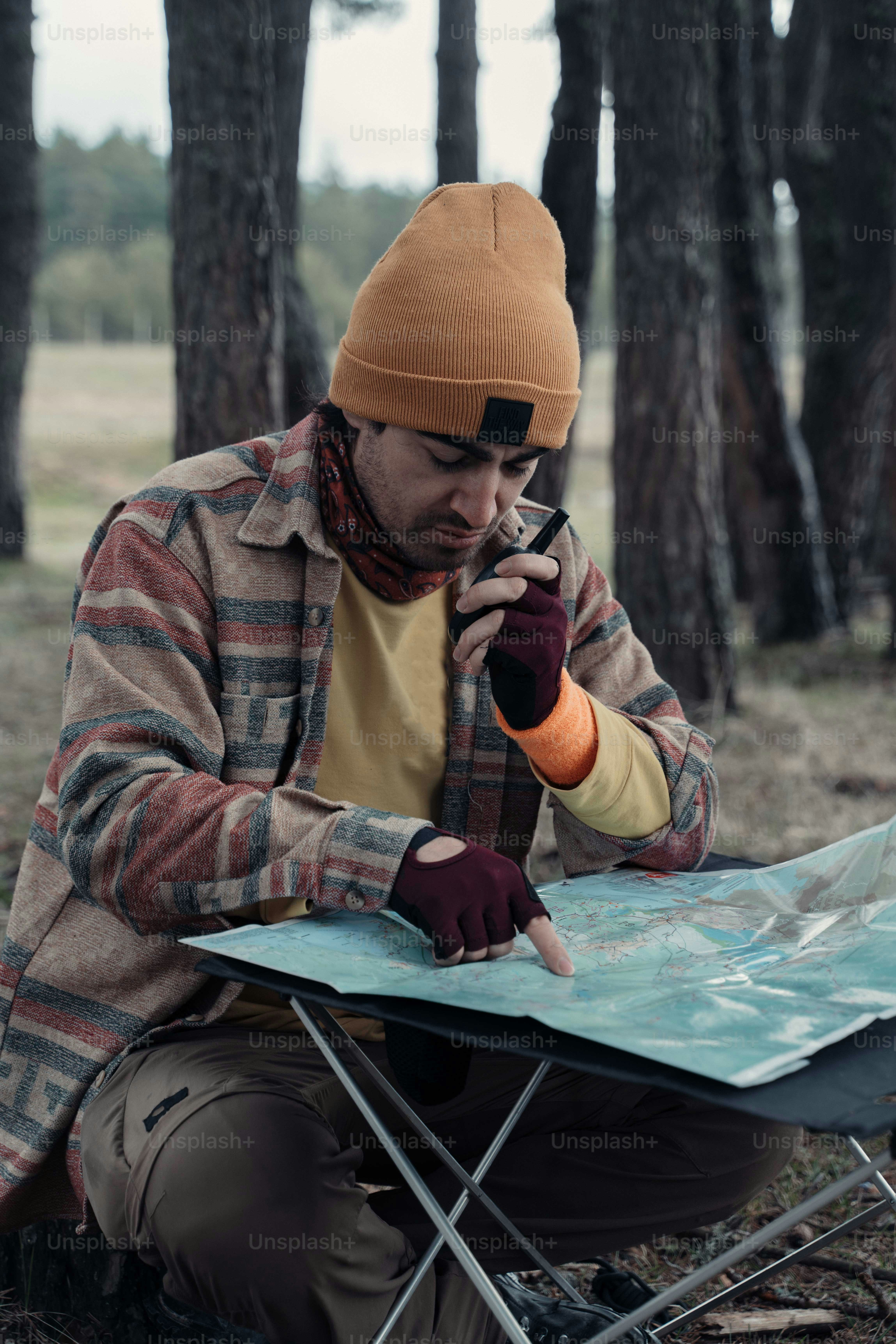 a man sitting on a camping chair in the woods