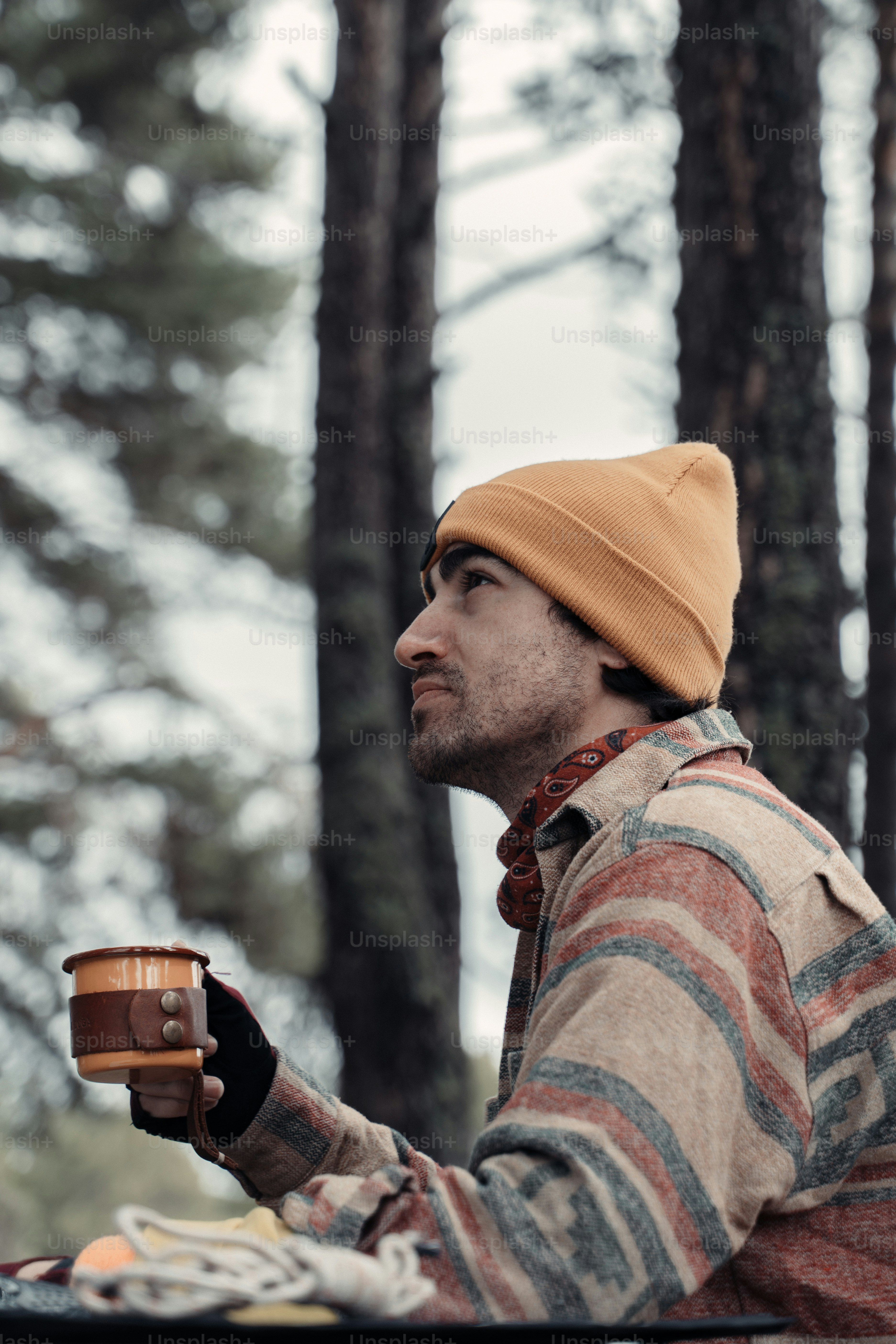 a man sitting at a table with a cup of coffee