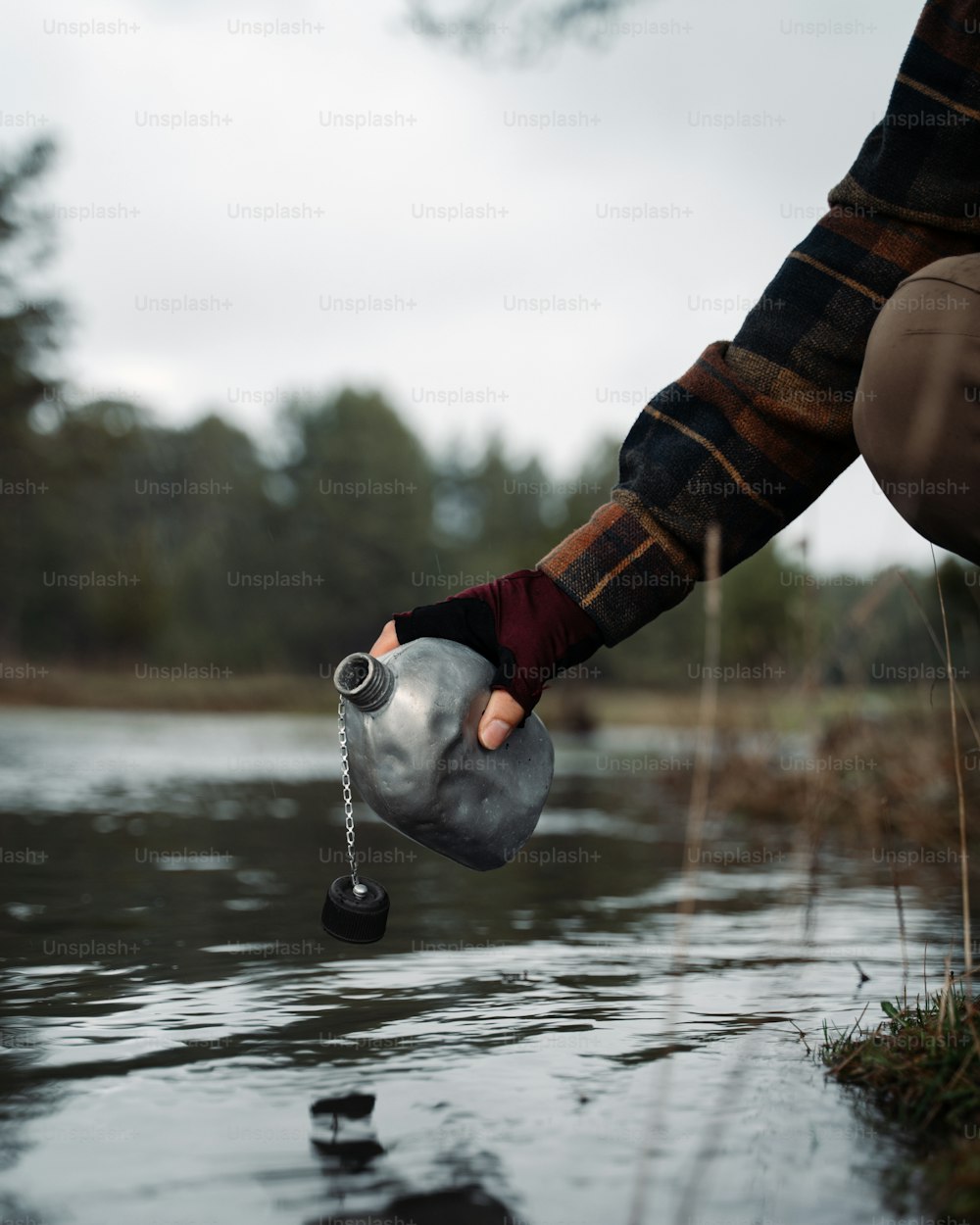 a person is holding a water jug in the water
