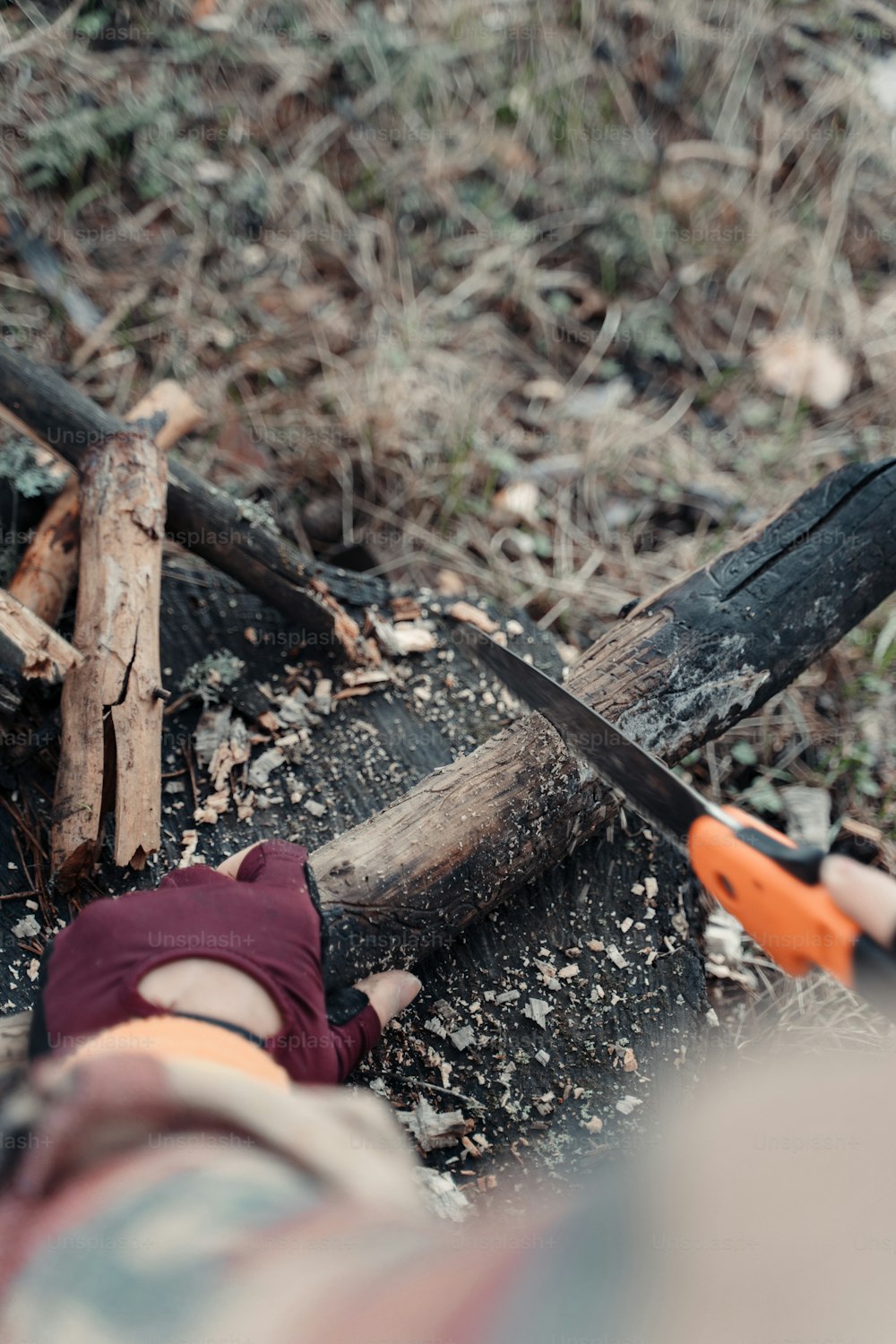 a pair of scissors laying on top of a pile of wood