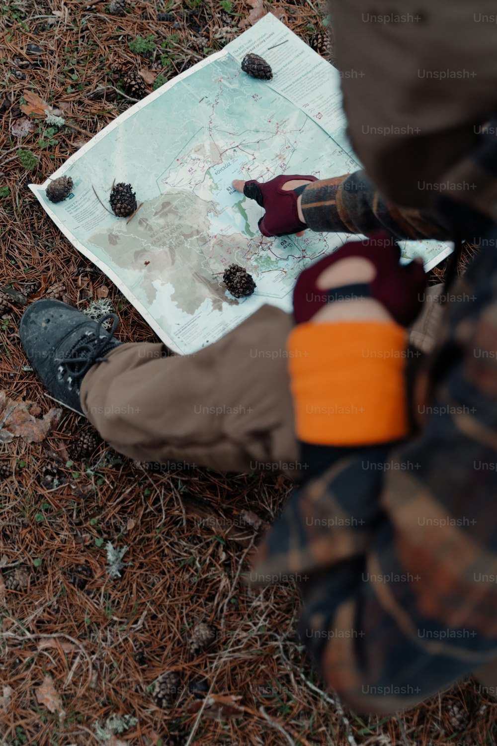 a man is looking at a map on the ground