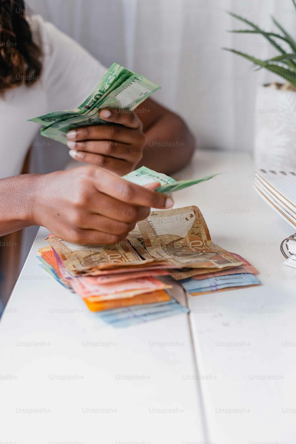 a person sitting at a table counting money